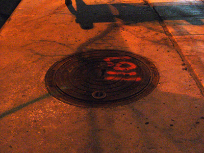 Manhole Cover by the Benches